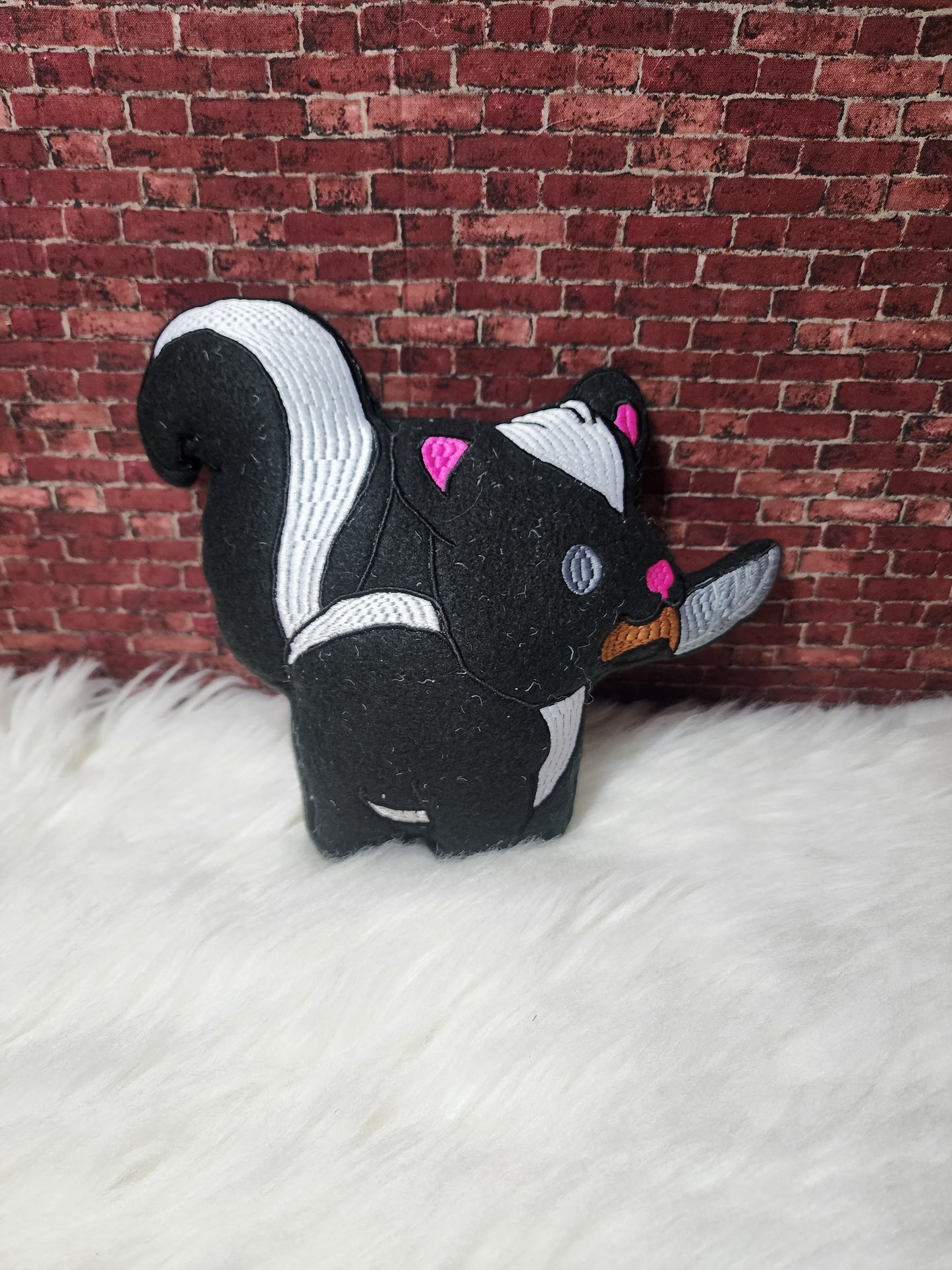 Skunk with knife plushie
